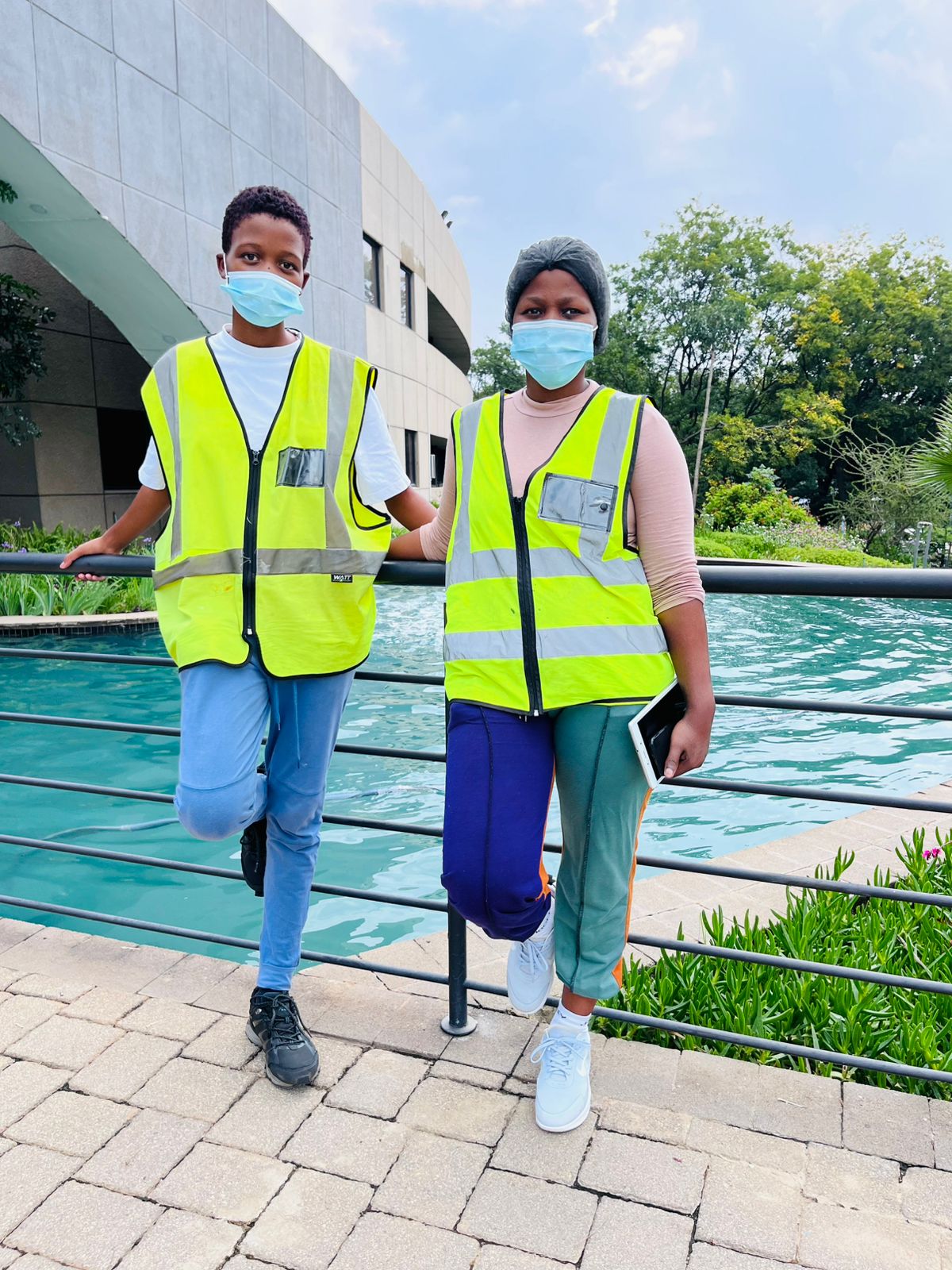 Workers wearing high-visibility vests walking outdoors